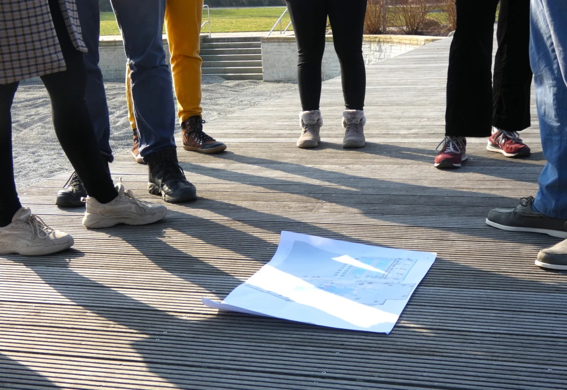 The ELCA team huddles around the site plan - initial orientation to the regeneration areas, swimming pools and technical installations 